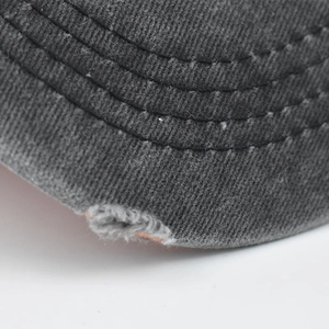 Macro shot of cotton twill fabric with multi-row stitching and distressed edge detail