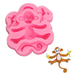 Pink silicone monkey mold for fondant featuring detailed banana accents for cake decorating