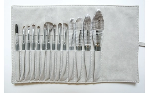 Detailed view of 14 grey makeup brushes with bionic bristles and a PU leather roll pouch
