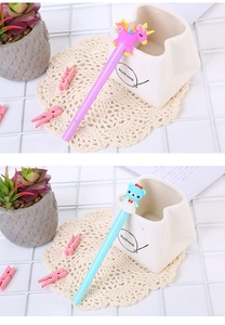 Cute unicorn and bear pens in a ceramic holder on a bright desk with accessories