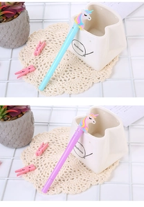 Close-up of cute cartoon unicorn pens in pink and blue colors on a tidy desk setup