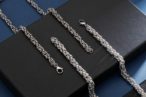 Detail of silver stainless steel keeled chain set with intricate braided link textures