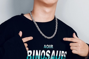 Close-up of a silver stainless steel dragon bone chain necklace worn by a male model