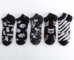 Detail view of five assorted low cut socks with geometric and character patterns