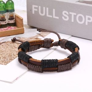 Detail of adjustable woven leather bracelet with vintage layered cords and brown base