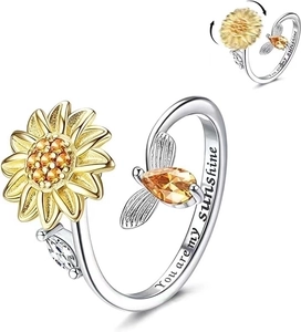 Detail of spinning sunflower ring with cubic zirconia and You are my sunshine engraving