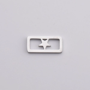 Macro detail of silver polished stainless steel square charm with hollow star pattern