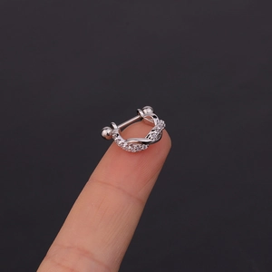U-shaped stainless steel cartilage earring with zircon stones shown on a finger