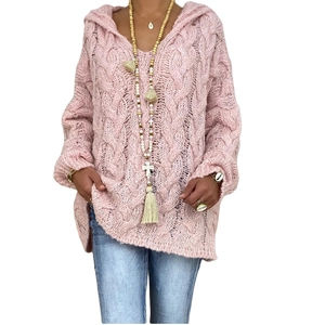 Detail of pink cable knit hoodie showing the chunky texture and oversized shoulder design