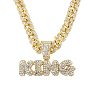 Golden hip hop Cuban link chain with a sparkling rhinestone-encrusted KING letter pendant