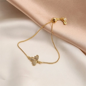 Detail of bee charm bracelet with pavé zircons and adjustable bolo slider closure