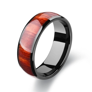Polished black stainless steel ring for men with elegant wood grain inlay on white background