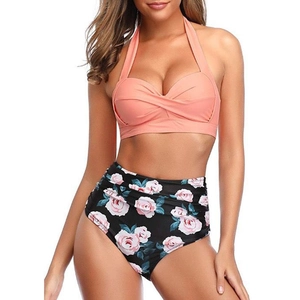 Detail of high waist floral bikini bottom with pink roses and black background