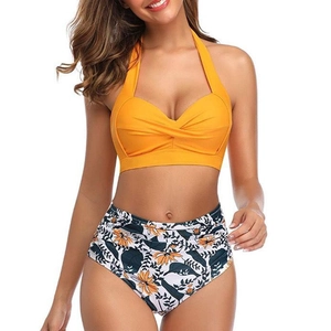 Detail of yellow twist halter bikini top with retro high waist floral printed bottom
