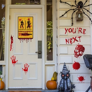Spooky Halloween stickers featuring bloody handprints and restroom signs on front door