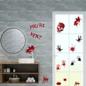 Scary Halloween bloody handprints and You Are Next lettering on bathroom tiles