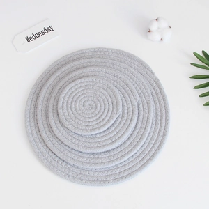 Detail view of 4-piece set grey woven cotton coasters in various sizes for table decor