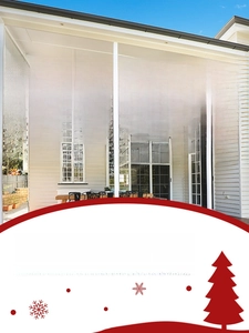 Outdoor Christmas banner with festive Santa graphics hanging on a modern white balcony