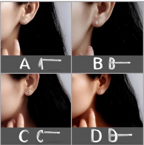 Detail view of S999 sterling silver alphabet earrings A B C D on female ear
