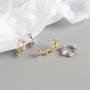 Detail of S925 sterling silver hoop earrings with round cubic zirconia in gold and silver