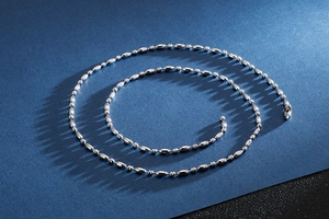 Detailed close-up of a polished silver stainless steel bamboo bead chain for men