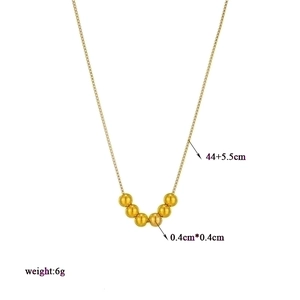 Golden titanium steel beaded necklace with seven round beads on a minimalist fine chain
