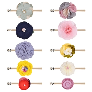 Detail view of 10 assorted baby bow headbands with floral fabric and pearl accents