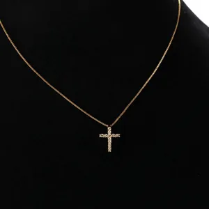 Gold cross necklace for women with micro-paved white zircons on a black display stand