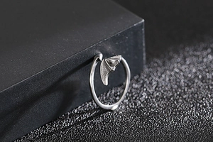 Close-up of gothic silver bat wing open ring with matte finish on black display box