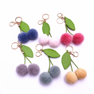 Cute cherry faux fur pompom keychain in six vibrant colors with green leaf accents