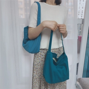 Detailed texture of lake blue canvas tote bag featuring reinforced stitching and shoulder strap