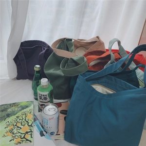 Detailed collection of colorful canvas tote bags in various vibrant shades and reinforced handles