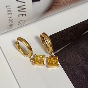 Detailed close-up of 18k gold plated earrings featuring yellow square zircon pendants