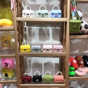 Retail shelf display showing mini PVC jelly bags with pearl handles and quilted design