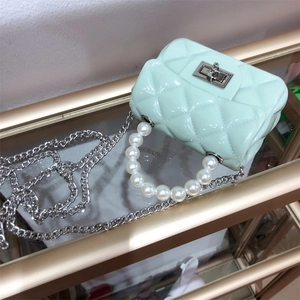 Top view of mint green quilted jelly mini bag with pearl handle and silver chain strap