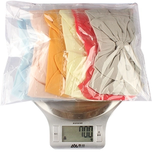 Detailed view of 6PCS soft nylon bow headbands set on a digital scale weighing 70.0 grams
