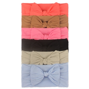 Detailed view of six colorful soft nylon baby headbands with large bow accents