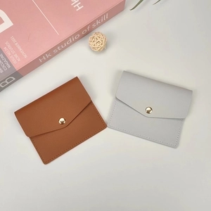 Slim envelope card holder in brown and blue leather with gold snap button closure