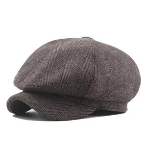 Classic dark brown herringbone newsboy cap in wool-like fabric shown from a 45-degree angle