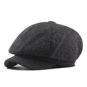 Classic dark grey tweed newsboy cap with herringbone texture and vintage 8-panel design