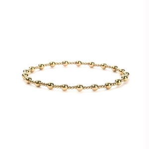 Detailed view of polished 18K gold-plated beaded elastic bracelet with metallic beads