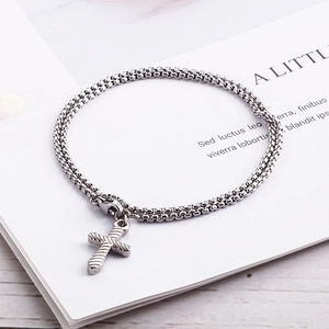 Double-layered silver stainless steel box chain bracelet featuring a cross pendant