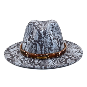 Detail of wide brim fedora with python print, brown leather band, and gold feather charm