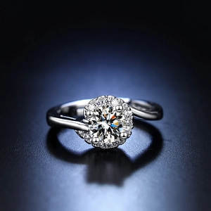 Macro shot of silver six-prong cubic zirconia ring with twisted band and halo design