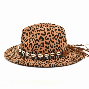 Detail of leopard print wool hat featuring shell beads and brown leather tassels