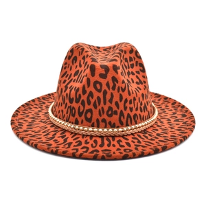 Detail of leopard print fedora hat featuring golden beaded trim and woven band decoration