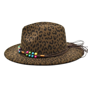 Detail of leopard print fedora hat featuring colorful beads and brown tassel accents