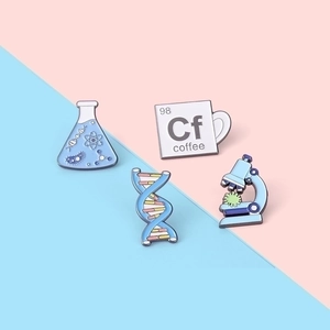 Science enamel pin set with microscope, DNA, flask, and coffee mug on pastel background