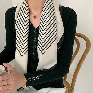 Elegant classic black and white striped silk scarf tied around neck for women fashion