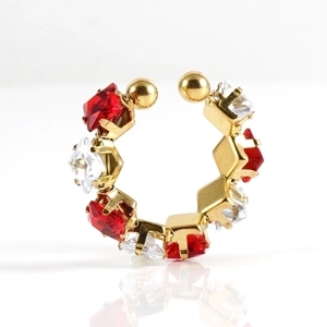 Close-up of gold ear cuff with alternating red and clear square zircon stones